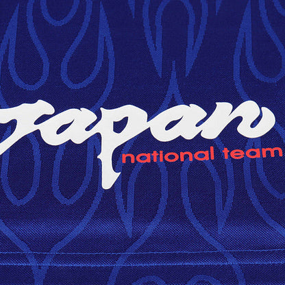 Text 'Japan national team' on a blue Japan 1998 home kids kit with flame pattern