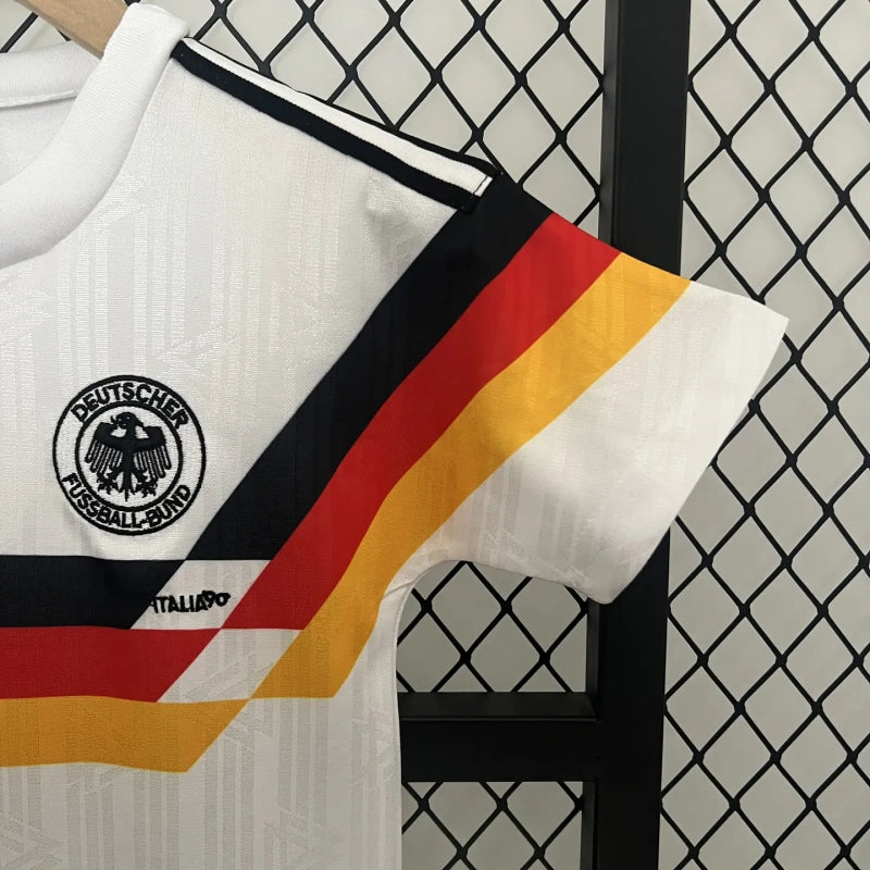 Vintage Germany 90 World Cup home kids kit  with flag design hanging on a rack.