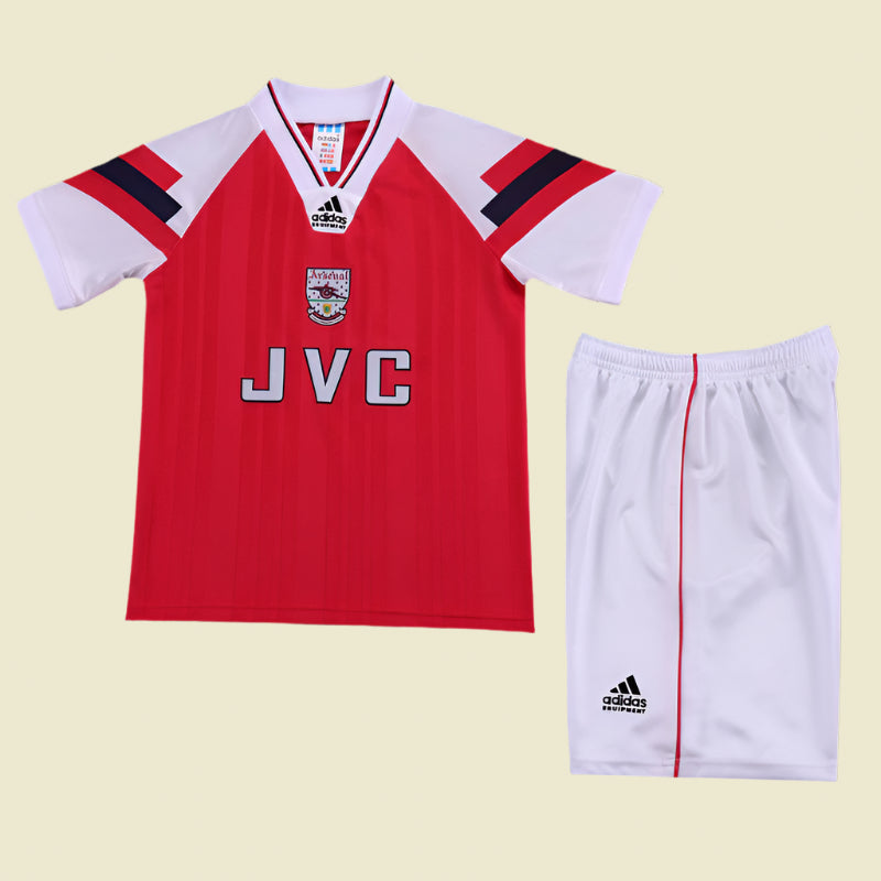 Red Arsenal 92-94 home kids kit with white sleeves and shorts on a textured gray background