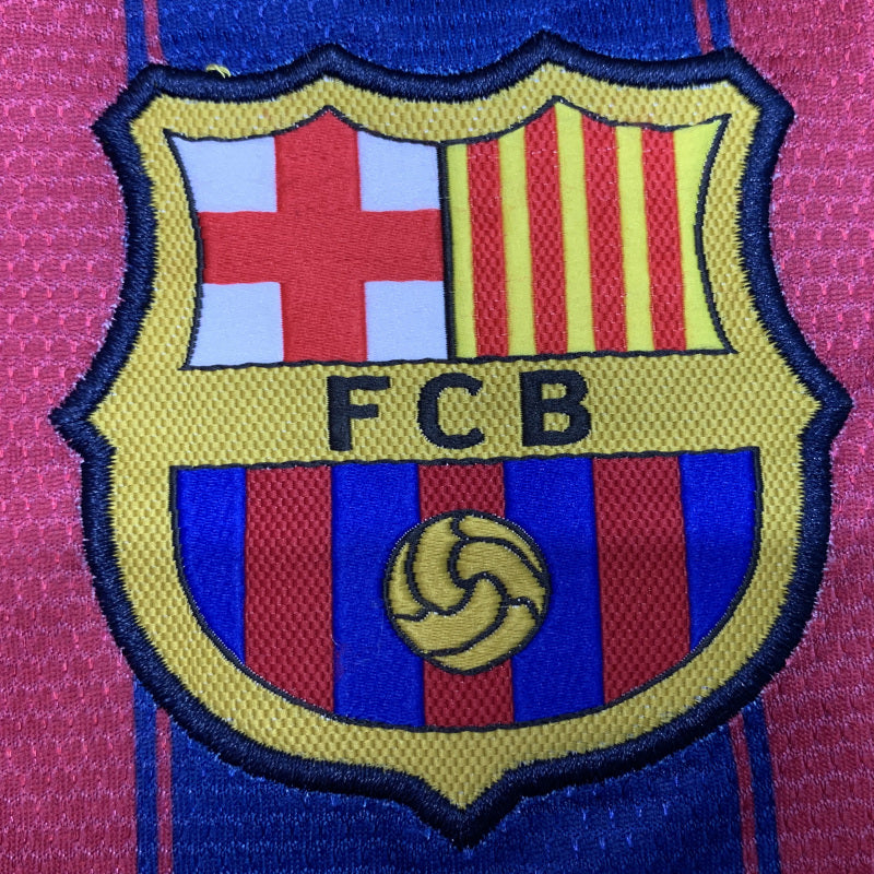 FCB logo on a Barcelona 09/10 home shirt with red, yellow, and blue colors.