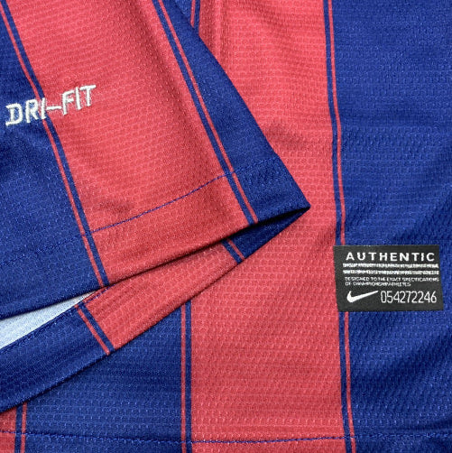 Close-up of a blue and red Barcelona 09/10 home shirt with 'Dri-Fit' and 'Authentic' labels.