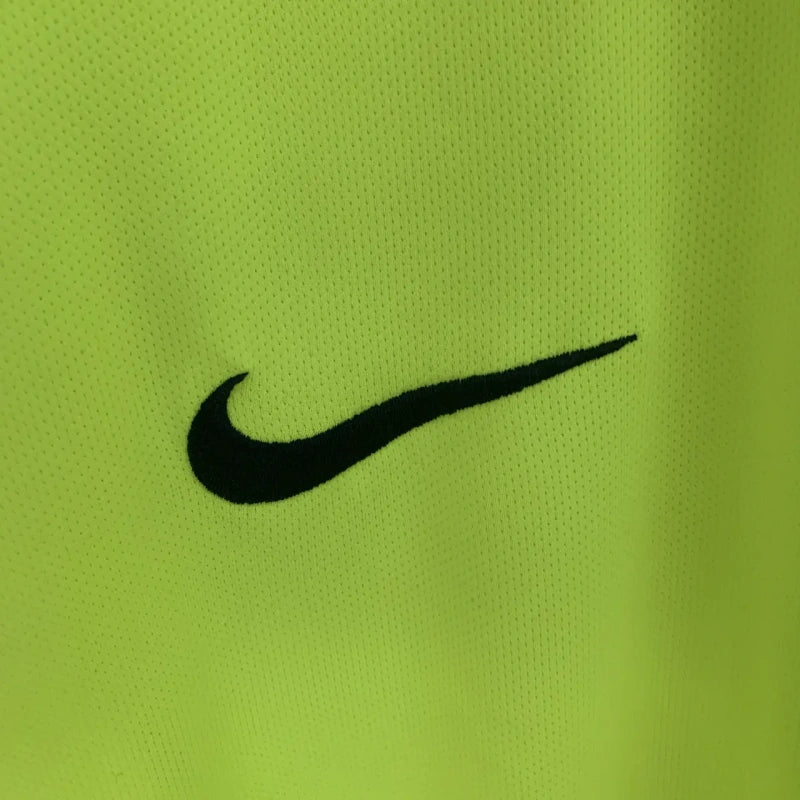 Black Nike logo on a green Barcelona 05/06 long sleeve away shirt