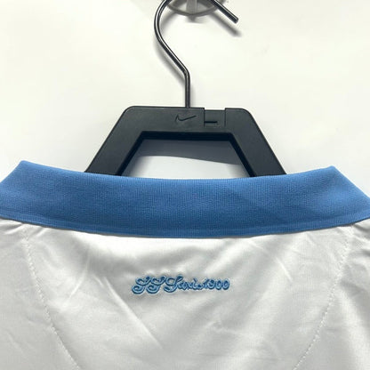 White Lazio 14/15 fourth shirt with blue collar on a hanger against a white background