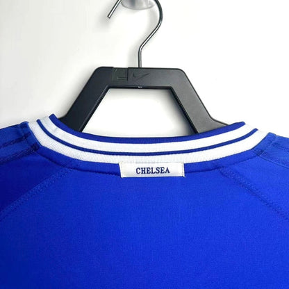 Blue Chelsea 99-01 home shirt with 'Chelsea' branding on a hanger against a white background