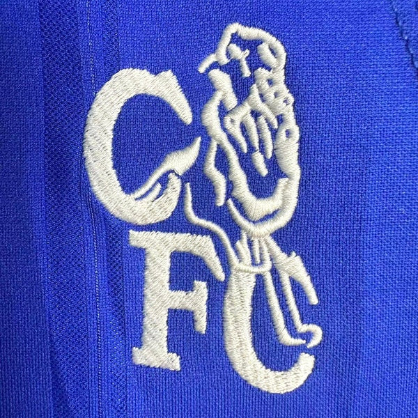 White embroidered logo on a blue Chelsea 99-01 home shirt
