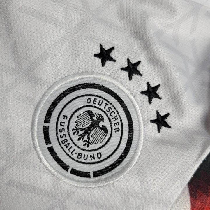 Deutscher Fussball-Bund logo on a Germany 2024 home baby onesie  with stars above it.