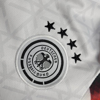 Deutscher Fussball-Bund logo on a Germany 2024 home baby onesie  with stars above it.