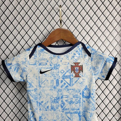 Portugal 2021 away baby onesie  with Nike logo and Portuguese emblem on a hanger against a tiled wall.