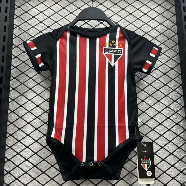 Black and red striped São Paulo 2024 away baby onesie  with SPFC logo on a hanger against a grid background