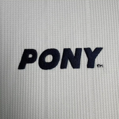Close-up of a Tottenham 97-99 long sleeve home shirt with 'PONY' logo.