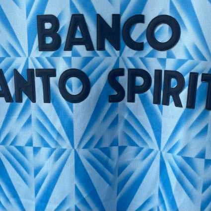Text 'BANCO SANTO SPIRITO' on a blue geometric patterned Lazio 91/92 home shirt