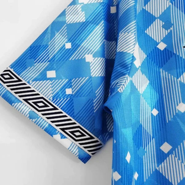 Blue patterned England 1990 third shirt with geometric designs on a white background