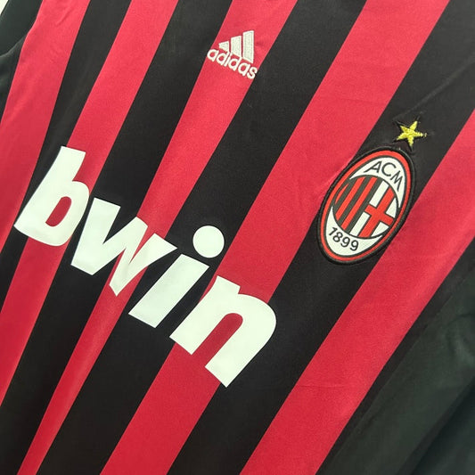 Red and black striped Ac Milan 09/10 long sleeve home shirt  with Adidas and AC Milan logos.