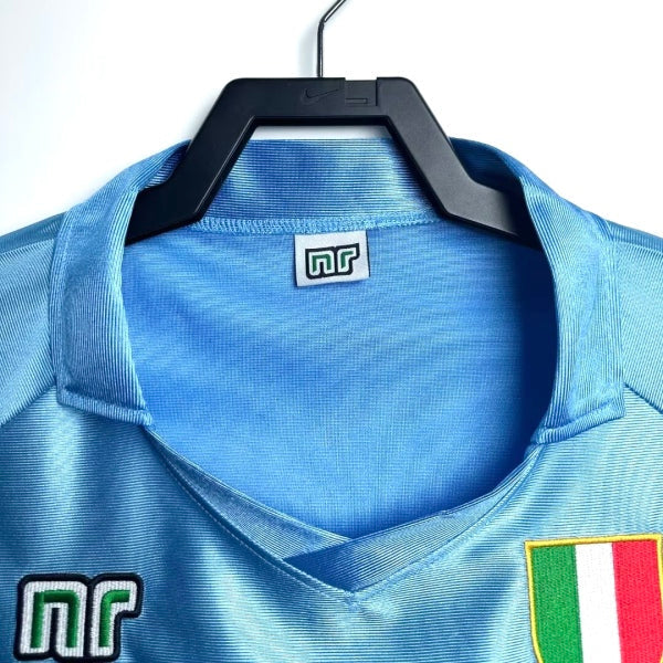 Blue Napoli 90/91 home 2nd shirt with a hanger on a white background