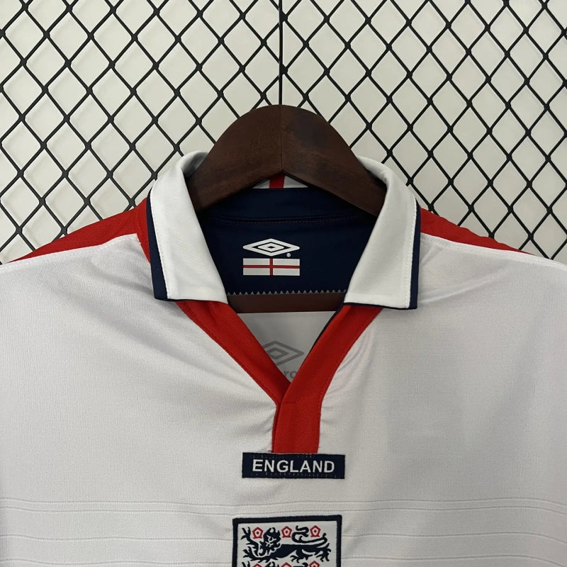 White England 2004 home shirt with red and blue accents on a hanger against a wire mesh background