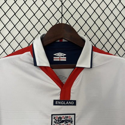White England 2004 home shirt with red and blue accents on a hanger against a wire mesh background