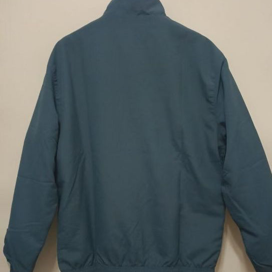 Flamengo 95/96 windbreaker jacket on a beige wall