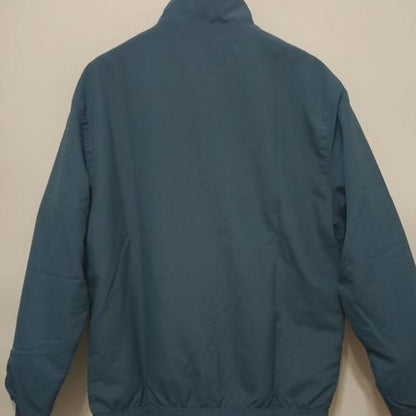 Flamengo 95/96 windbreaker jacket on a beige wall