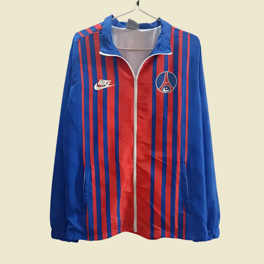 Blue and red striped jacket with Nike and Paris Saint-Germain logos on a gray background