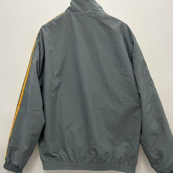 Gray Arsenal 91-93 away windbreaker jacket with yellow stripes on a white background