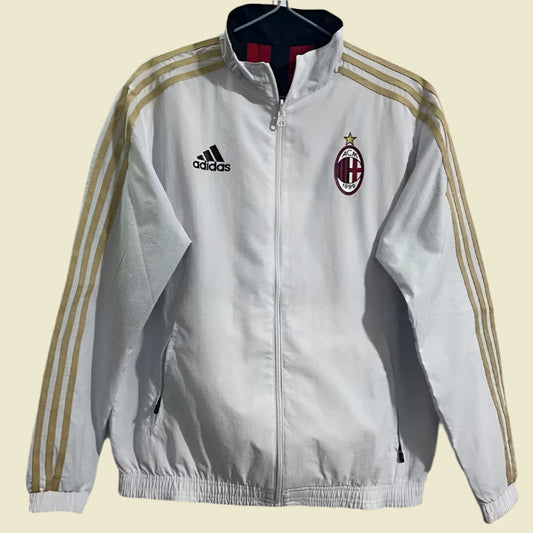 White jacket with Adidas and AC Milan logos on a beige background